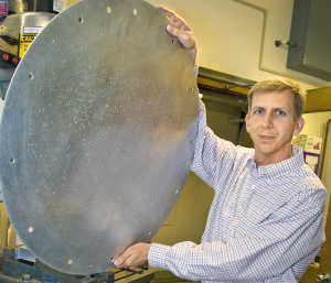 David Schlegel holding one of many large metal plug plates