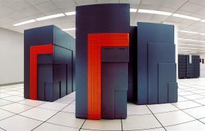 Three black monolith-like cabinets dominate a fish-eye view of a data center.