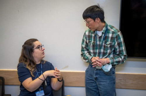 two people confer