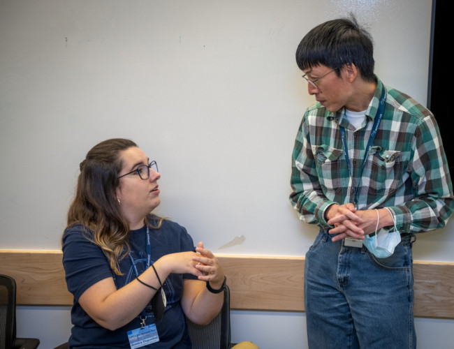 two people confer