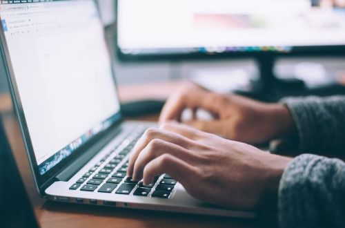 hands on a laptop keyboard