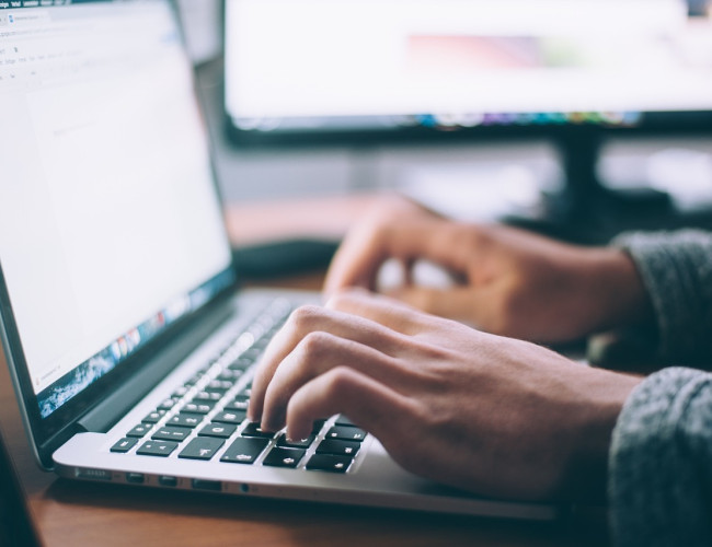 hands on a laptop keyboard