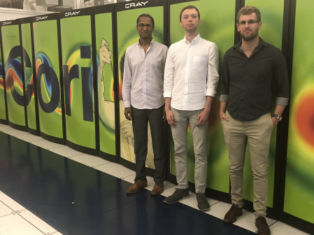 Three scientists in front of the Cori supercomputer at NERSC