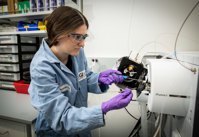JGI researcher works with sequencing equipment
